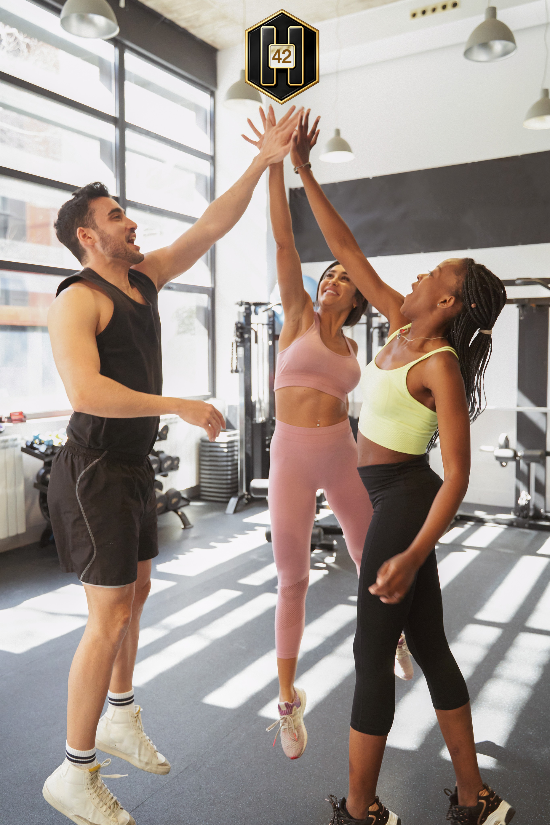 A Habit42 cohort celebrating a workout together with a group high-five.